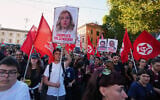 Pro-Palestinian demonstrators bearing placards with pictures of Italian Premier Giorgia Meloni reading in Italian "Complicit in genocide," gather in Rome's San Giovanni Square, October 4, 2025. (AP/Alessandra Tarantino)