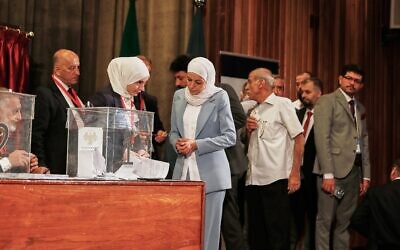 Syrian electoral college members line up to cast their ballots in a parliamentary election at a polling station in Damascus, on October 5, 2025. (AP/Omar Sanadiki)