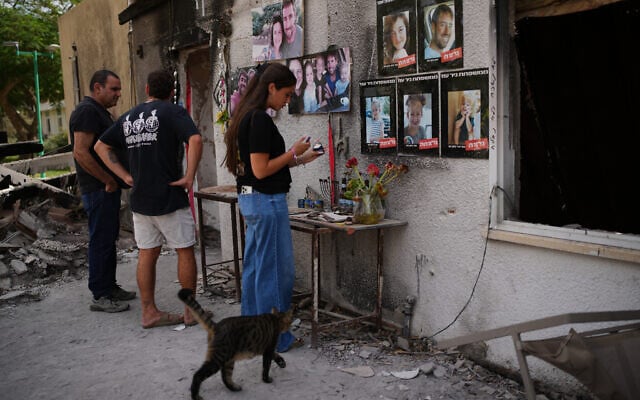 People visit the burnt house of the Siman Tov family, where all five family members were killed during the Hamas attack on October 7, 2023, in Kibbutz Nir Oz, Israel, a day before Israel marks the two-year anniversary of the attack, Monday, Oct. 6, 2025. (AP/Ohad Zwigenberg)