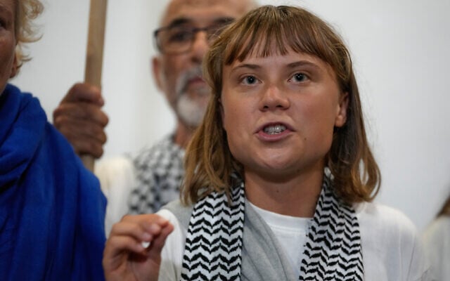 Swedish campaigner Greta Thunberg speaks as she arrives at the Eleftherios Venizelos International Airport in Athens, Monday, Oct. 6, 2025 after being deported from Israel along with other pro-Palestinian activists from the Gaza-bound flotilla. (AP Photo/Petros Giannakouris)