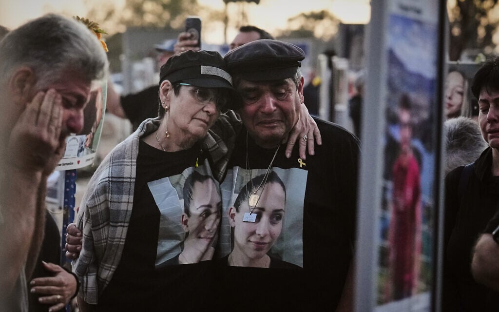 The parents of Shiran Slavin visit the site of the Nova music festival near Kibbutz Reim in southern Israel, where she and hundreds of others were killed and abducted during the deadly Hamas cross-border attack on Oct. 7, 2023, as Israel marks the second anniversary of the attack, Oct. 7, 2025. (AP Photo/Ariel Schalit)