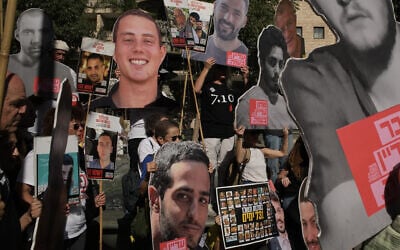 Relatives and supporters of Israeli hostages held by Hamas in the Gaza Strip hold posters with portraits of their loved ones during a protest demanding their immediate release and calling for a ceasefire, in Jerusalem, October 7, 2025, on the second anniversary of Hamas' cross-border attack on Israel on October 7, 2023, which sparked the ongoing war in Gaza. (AP Photo/Leo Correa)