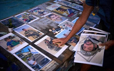 Israelis tend to the makeshift memorial at Tel Aviv's Dizengoff Square on the massacre's second anniversary, October 7, 2025. (AP Photo/Emilio Morenatti)