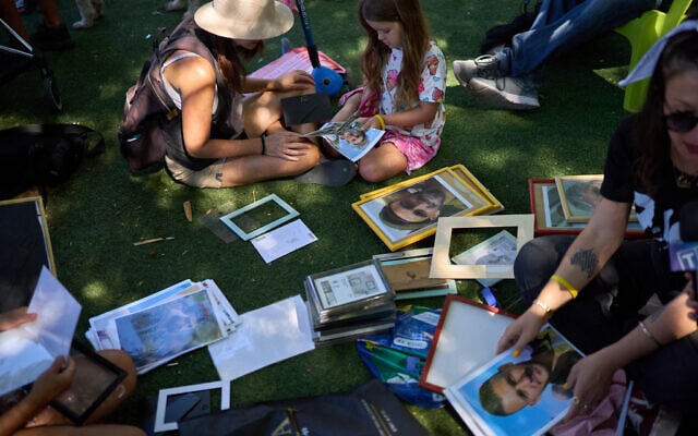 Activists re-frame photos of people killed in the Hamas onslaught of October 7, 2023, at a memorial marking two years since the invasion that sparked the Gaza war, at Tel Aviv's Dizengoff Square, October 7, 2025. (AP Photo/Emilio Morenatti) Activists re-frame photos of people killed in the Hamas onslaught of October 7, 2023, at a memorial marking two years since the invasion that sparked the Gaza war, at Tel Aviv's Dizengoff Square, October 7, 2025. (AP Photo/Emilio Morenatti)