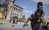 Syrian security forces stand guard as residents leave the Sheikh Maqsoud and Achrafieh neighborhoods of Aleppo, Syria, October 7, 2025, following overnight clashes between Syrian government troops and the Kurdish-led Syrian Democratic Forces. (AP Photo/Omar Albam)