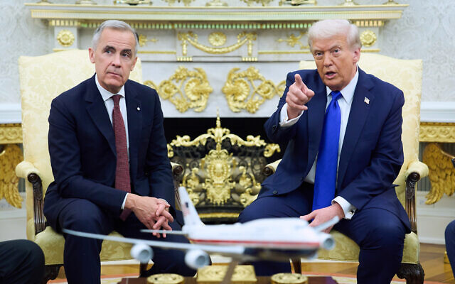 President Donald Trump answers questions as he hosts Canadian Prime Minister Mark Carney in the Oval Office of the White House, Oct. 7, 2025, in Washington. (AP Photo/Evan Vucci)