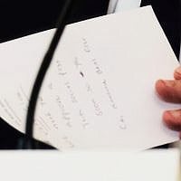 US Secretary of State Marco Rubio writes a note before handing it to President Donald Trump during a roundtable meeting in the State Dining Room at the White House, October 8, 2025, in Washington. (AP Photo/Evan Vucci)