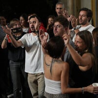Former hostages, relatives of hostages and supporters celebrate after the announcement that Israel and Hamas have agreed to the first phase of US President Donald Trump's Gaza peace plan, in Hostages Square in Tel Aviv early on Thursday, Oct. 9, 2025. (AP Photo/Emilio Morenatti)