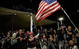 Freed captives, relatives of hostages  and their supporters celebrate after the announcement that Israel and Hamas have agreed to the first phase of Gaza ceasefire plan, as they gather at Hostages Square in Tel Aviv, October 9, 2025. (AP/Ohad Zwigenberg)