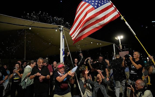 Freed captives, relatives of hostages  and their supporters celebrate after the announcement that Israel and Hamas have agreed to the first phase of Gaza ceasefire plan, as they gather at Hostages Square in Tel Aviv, October 9, 2025. (AP/Ohad Zwigenberg)