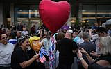 A person wears a mask depicting US President Donald Trump Israelis celebrate following the announcement that Israel and Hamas have agreed to the first phase of a peace plan to pause the fighting, Tel Aviv, Israel, October 9, 2025. (AP/Emilio Morenatti)