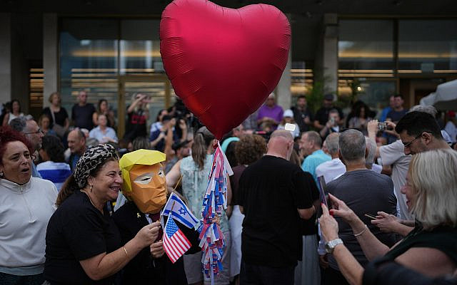 A person wears a mask depicting US President Donald Trump Israelis celebrate following the announcement that Israel and Hamas have agreed to the first phase of a peace plan to pause the fighting, Tel Aviv, Israel, October 9, 2025. (AP/Emilio Morenatti) A person wears a mask depicting US President Donald Trump Israelis celebrate following the announcement that Israel and Hamas have agreed to the first phase of a peace plan to pause the fighting, Tel Aviv, Israel, October 9, 2025. (AP/Emilio Morenatti)