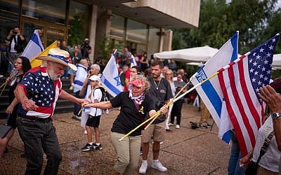 People dance as they celebrate following the announcement that Israel and Hamas have agreed to the first phase of a peace plan to pause the fighting, at a plaza known as hostages square in Tel Aviv, Israel, October 9, 2025. (AP Photo/Emilio Morenatti)
