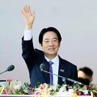 Taiwanese President Lai Ching-te waves during National Day celebrations in front of the Presidential Building in Taipei, Taiwan, on October 10, 2025. (AP Photo/Chiang Ying-ying)