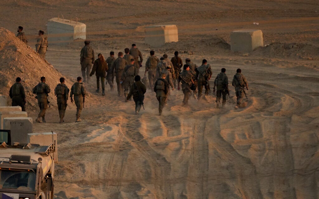 Israeli soldiers walk near the Israel-Gaza border, as seen from southern Israel, October 10, 2025. (AP/Emilio Morenatti)