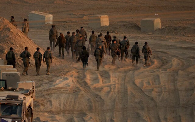 Israeli soldiers walk near the Israel-Gaza border, as seen from southern Israel, October 10, 2025. (AP/Emilio Morenatti)