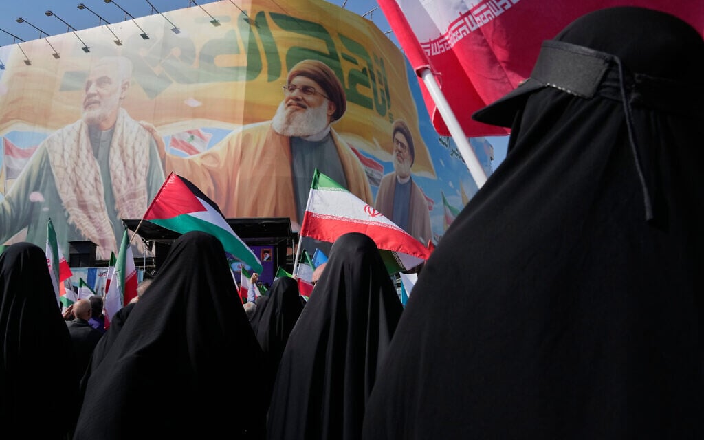 Iranian women wave Palestinian and Iranian flags in front of a banner showing the late commander of the Iranian Revolutionary Guard expeditionary Quds Force, Gen. Qassem Soleimani, left, and two late Hezbollah leaders Hassan Nasrallah, center, and Hashem Safieddine, during an anti-Israeli rally after the Friday prayers at the Enghelab-e-Eslami (Islamic Revolution) Square, in Tehran, Iran, October 10, 2025. (AP Photo/Vahid Salemi) Iranian women wave Palestinian and Iranian flags in front of a banner showing the late commander of the Iranian Revolutionary Guard expeditionary Quds Force, Gen. Qassem Soleimani, left, and two late Hezbollah leaders Hassan Nasrallah, center, and Hashem Safieddine, during an anti-Israeli rally after the Friday prayers at the Enghelab-e-Eslami (Islamic Revolution) Square, in Tehran, Iran, October 10, 2025. (AP Photo/Vahid Salemi)