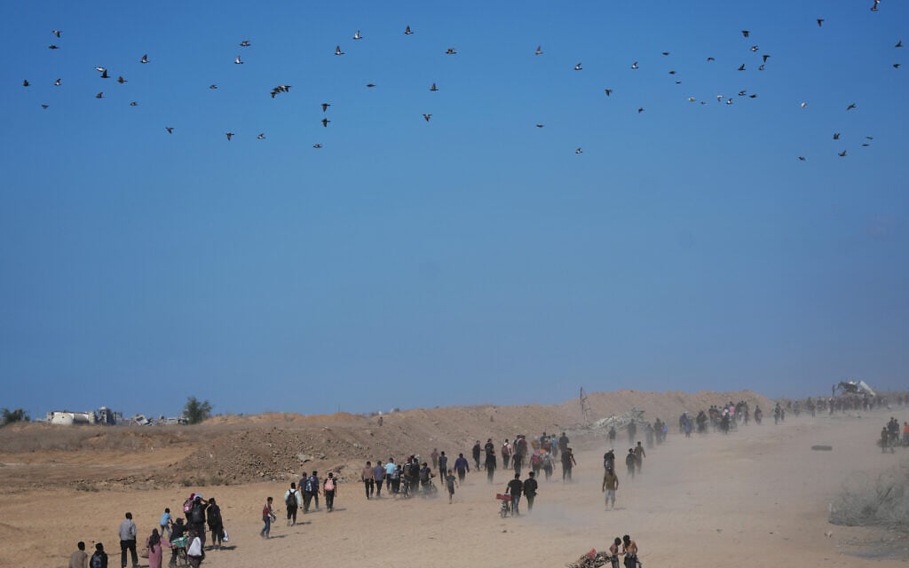 Displaced Palestinians walk toward Gaza City, in the northern Gaza Strip, October 10, 2025, after Israel and Hamas agreed to a ceasefire. (AP Photo/Jehad Alshrafi)