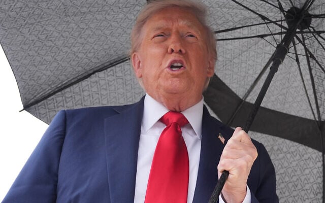 US President Donald Trump speaks to reporters before boarding Air Force One, October 12, 2025, at Joint Base Andrews, Maryland, as he heads to the Middle East. (AP Photo/Evan Vucci)