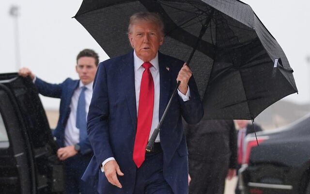 US President Donald Trump walks over to speak with reporters before boarding Air Force One, October 12, 2025, at Joint Base Andrews, Maryland, as he heads to the Middle East. (AP Photo/Evan Vucci)