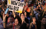 People celebrate as they watch a live broadcast of the release of Israeli hostages after more than two years of Hamas captivity, at Hostages Square in Tel Aviv, October 13, 2025. (AP Photo/Oded Balilty)