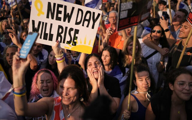 People celebrate as they watch a live broadcast of the release of Israeli hostages after more than two years of Hamas captivity, at Hostages Square in Tel Aviv, October 13, 2025. (AP Photo/Oded Balilty)