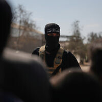 A masked Hamas gunman in Khan Younis, southern Gaza Strip, ahead of handing over Israeli hostages to the Red Cross, October 13, 2025. (AP Photo/Abdel Kareem Hana)