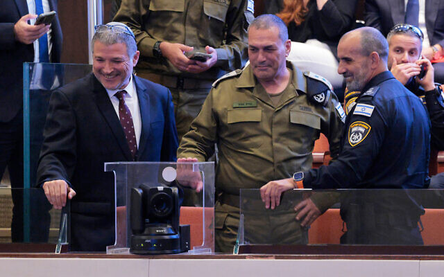 Shin Bet head David Zini, left, speaks with IDF chief Lt. Gen. Eyal Zamir (C) and Commissioner-General Daniel Levi as US President Donald Trump arrives to address the Knesset, October 13, 2025 in Jerusalem. (Chip Somodevilla/Pool via AP)