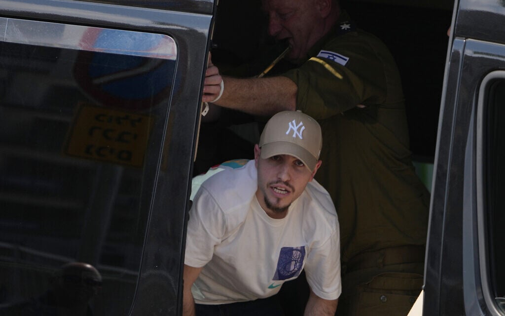 Freed Israeli hostage Eitan Mor looks out of a van upon arriving at Beilinson Hospital in Petah Tikva, Israel, after being released from Hamas captivity in the Gaza Strip, October 13, 2025. (AP Photo/Ariel Schalit)