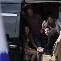 Freed Israeli hostage Alon Ohel gestures from a van as he arrives at Beilinson Hospital in Petah Tikva, Israel, after he was released from Hamas captivity in the Gaza Strip, Oct. 13, 2025. (AP Photo/Ariel Schalit)