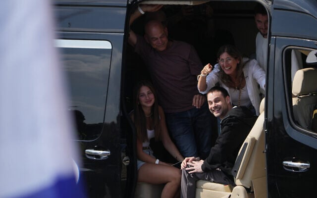Freed Israeli hostage Alon Ohel gestures from a van as he arrives at Beilinson Hospital in Petah Tikva, Israel, after he was released from Hamas captivity in the Gaza Strip, Oct. 13, 2025. (AP Photo/Ariel Schalit)