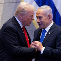 US President Donald Trump (left) talks with Prime Minister Benjamin Netanyahu in the Knesset, October 13, 2025. (Chip Somodevilla/Pool via AP)