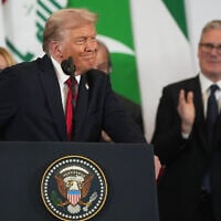 US President Donald Trump stands at the podium during a summit on peace in Gaza, amid applause from leaders including Britain's Prime Minister Keir Starmer, right, in the Egyptian resort town of Sharm El-Sheikh, October 13, 2025. (AP Photo/Amr Nabil)