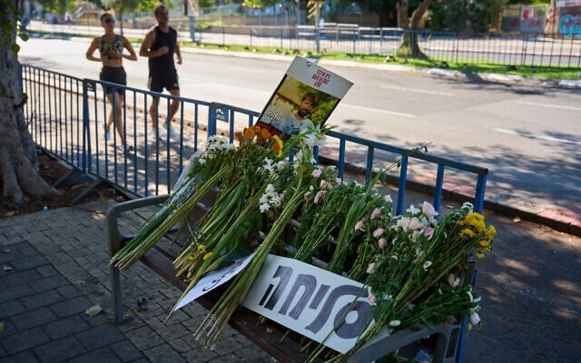 Flowers and a sign written in Hebrew that reads 'Sorry' are placed on a bench outside Abu Kabir, the forensic institute where the identification process is being carried out on the four hostage bodies that were handed over by Hamas in the Gaza Strip, in Tel Aviv, Oct. 14, 2025. (AP Photo/Emilio Morenatti)