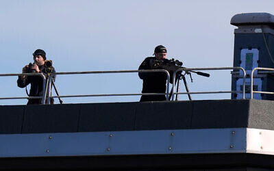 Snipers patrol on the roof of the Fruili Hotel where the Israeli national team is staying, ahead of a World Cup 2026, Group I qualifying soccer match between Italy and Israel at the Friuli Stadium in Udine, Italy, Tuesday, Oct.14, 2025. (AP Photo/Luca Bruno)