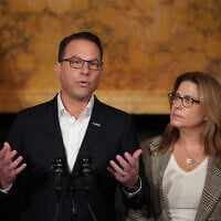 Pennsylvania Gov. Josh Shapiro, accompanied by his wife Lori Shapiro, speaks during a news conference after Cody Balmer, who set fire to Shapiro's residence, pled guilty to attempted murder and other charges, on Tuesday, October 14, 2025 in Harrisburg, Pennsylvania. (AP Photo/Matt Slocum)