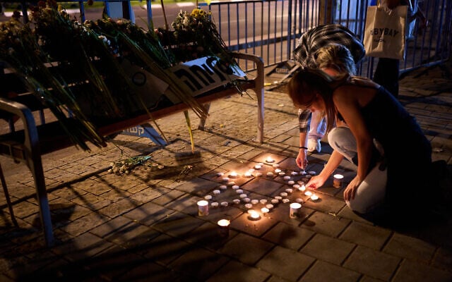 People light candles outside Abu Kabir, the forensic institute where the identification process is being carried out on the bodies that were held by Hamas in the Gaza Strip, in Tel Aviv, Oct. 14, 2025. (AP Photo/Emilio Morenatti)
