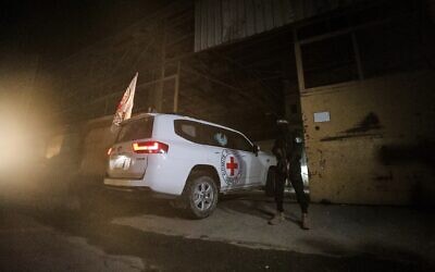 A gunman wearing the uniform of the al-Qassam Brigades, the military wing of Hamas, stands guard as Red Cross vehicles enter a warehouse allegedly to collect coffins containing the bodies of four deceased hostages, in Gaza City, October 14, 2025. (AP Photo/Yousef Al Zanoun) A gunman wearing the uniform of the al-Qassam Brigades, the military wing of Hamas, stands guard as Red Cross vehicles enter a warehouse allegedly to collect coffins containing the bodies of four deceased hostages, in Gaza City, October 14, 2025. (AP Photo/Yousef Al Zanoun)