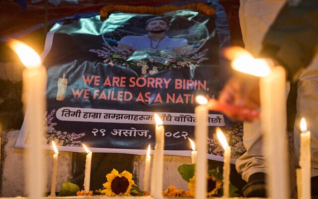 People participate in a candlelight vigil for Bipin Joshi, a Nepali man who was taken hostage by Hamas on October 7, 2023, and was recently declared dead and his body transferred to Israel, in Kathmandu, Nepal, October 15, 2025. (AP Photo/Niranjan Shrestha)
