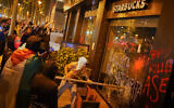Rioters break the shop window of a Starbucks during anti-Israel demonstrations in Barcelona on October 15, 2025. (AP Photo/Joan Mateu Parra)