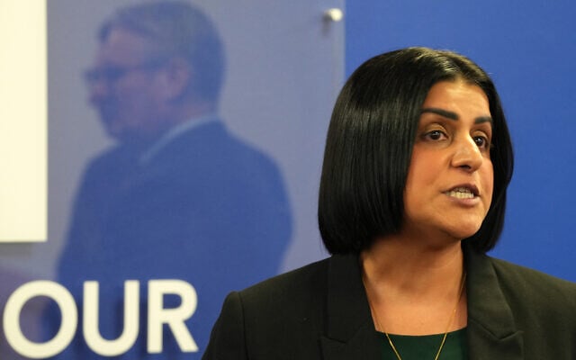 Britain's Prime Minister Keir Starmer, left, is reflected as Britain's Home Secretary Shabana Mahmood speaks to members of the Jewish community at the Community Security Trust (CST) in north west London, Oct. 16, 2025. (Carlos Jasso, Pool Photo via AP)