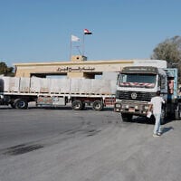Trucks carrying humanitarian aid wait at the Rafah Crossing on the Gaza-Egypt border, on October 16, 2025. (AP Photo/Mohamed Arafat)