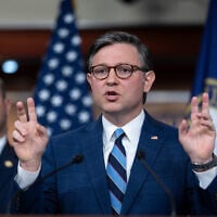 US House Speaker Mike Johnson, joined at left by US Rep. Andrew Garbarino, gestures as he answers questions during a press conference on the sixteenth day of a government shutdown, at the Capitol in Washington, October 16, 2025. (AP/J. Scott Applewhite)