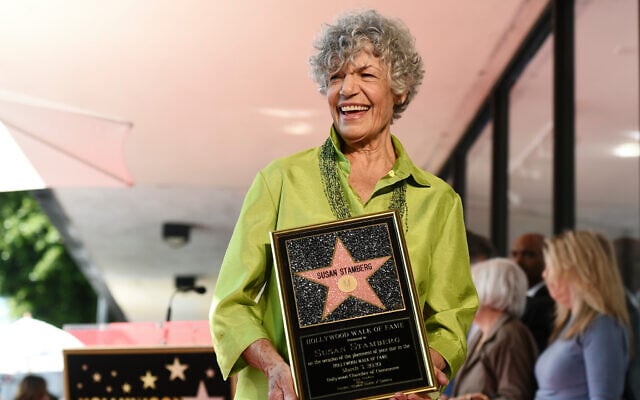 National Public Radio broadcast journalist Susan Stamberg holds up a replica of her new star on the Hollywood Walk of Fame following a ceremony, in Los Angeles, California, March 3, 2020. (AP Photo/Chris Pizzello)