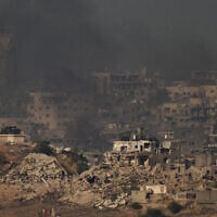Buildings that were destroyed during the fighting between Israel and Hamas are seen in the northern Gaza Strip during the sunrise, as seen from southern Israel, October 17, 2025. (AP Photo/Leo Correa)