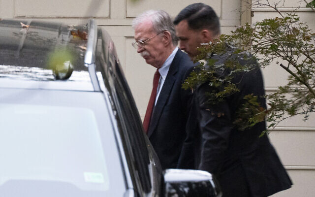 John Bolton, left, who served as US President Donald Trump's national security adviser during his first term, leaves his house in Bethesda Maryland, Oct. 17, 2025. (AP Photo/Manuel Balce Ceneta)