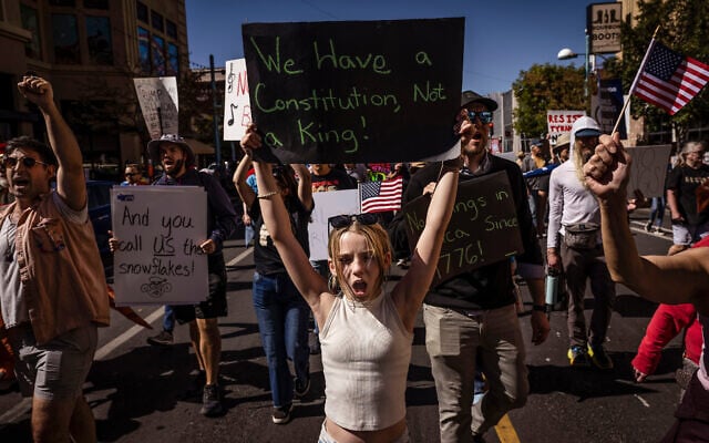 Daniella Diener participates with other protesters in the 'No Kings' rally and march in downtown Albuquerque, New Mexico, October 18, 2025. (Chancey Bush/The Albuquerque Journal via AP)