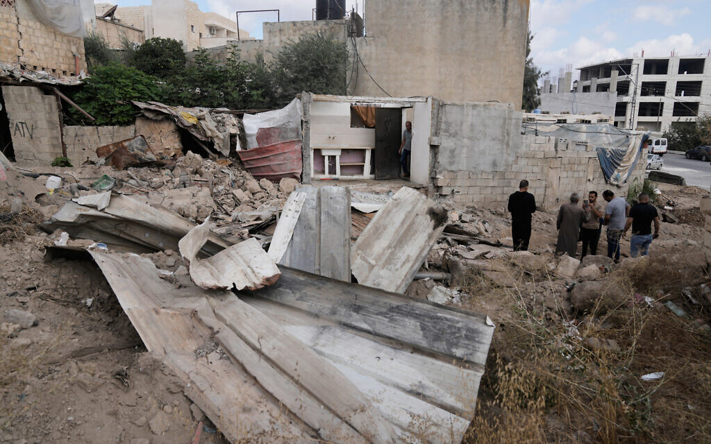 Palestinians stand next to a destroyed road following an Israeli military operation in the West Bank town of Tubas, Oct. 19, 2025. (AP/Majdi Mohammed)