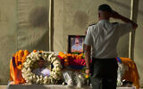 A member of the Nepalese army pays his respects to Bipin Joshi, a Nepali man who was taken hostage by Hamas, during a memorial procession at Tribhuvan International Airport in Kathmandu, Nepal, October 20, 2025. (AP/Niranjan Shrestha)