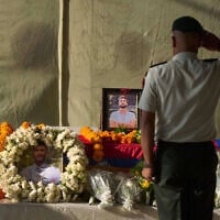 A member of the Nepalese army pays his respects to Bipin Joshi, a Nepali man who was taken hostage by Hamas, during a memorial procession at Tribhuvan International Airport in Kathmandu, Nepal, October 20, 2025. (AP/Niranjan Shrestha)